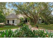 Charming single-story home with lush landscaping and a brick pathway at 5138 Fairway Oaks Dr, Windermere, FL 34786