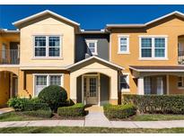 Townhouse featuring neutral color palette, manicured landscaping, inviting entrance, and well-maintained walkway at 5316 Factors Walk Drive, Sanford, FL 32771