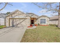Charming single-story home featuring a two-car garage and a well-manicured front lawn at 615 Blue Park Rd, Orange City, FL 32763