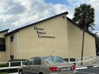 Exterior view of Destiny Springs Condominium building with lush landscaping at 946 Lake Destiny Rd # D, Altamonte Springs, FL 32714