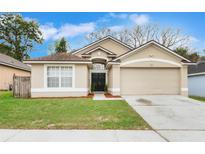 Charming single-Gathering home featuring a well-maintained lawn and a two-car garage at 2284 Cobblefield Cir, Apopka, FL 32703