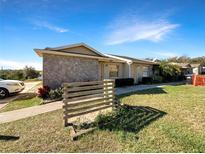 Charming exterior view of a single-story home with a stone accent wall and well-maintained landscaping at 1172 Woodman Way, Orlando, FL 32818