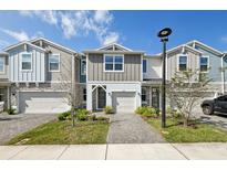Charming townhome featuring a paved walkway and a one-car garage for convenient parking and curb appeal at 1412 Captiva Cv, Sanford, FL 32771