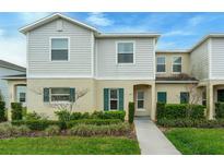 Charming two-story home with a well-manicured lawn and landscaped garden and welcoming front entrance at 157 Primrose Dr, Davenport, FL 33837