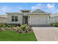Charming single-story home featuring a two-car garage, well-manicured lawn, and a brick driveway at 2120 Antilles Club Dr # 10, Kissimmee, FL 34747