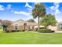 Charming single-story home featuring brick accents and a beautifully landscaped front yard with mature trees at 2732 Lone Feather Dr, Orlando, FL 32837