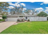 Charming single Gathering home featuring a well manicured lawn and lovely white picket fence at 4522 Flagg St, Orlando, FL 32812