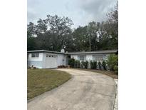 Charming single story home with a curved driveway and attached garage at 5815 Holmes Dr, Orlando, FL 32808