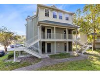 Charming two-story building showcasing elevated entryways and staircase at 6178 Westgate Dr # 304, Orlando, FL 32835