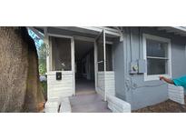 Charming front entrance with screen door, white accents, and steps leading into the home at 1029 Colyer St, Orlando, FL 32805