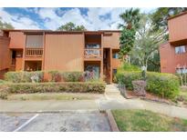 Two-story condo with a balcony, a palm tree in the front yard, and a well-maintained landscaped exterior at 1038 E Michigan St # B, Orlando, FL 32806