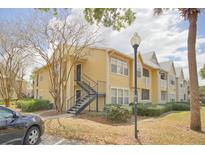 Charming two-story condo building featuring well-maintained landscaping and a private entry staircase at 1043 S Hiawassee Rd # 3111, Orlando, FL 32835