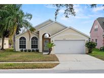 Charming single Gathering home with a well-manicured lawn and attached two car garage at 15832 Autumn Glen Ave, Clermont, FL 34714