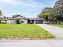 Charming single-story home with well-manicured lawn and two-car garage at 412 Parson Brown Way, Longwood, FL 32750