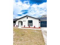 Charming single-story home featuring white stucco, well-defined lines, and fresh landscaping at 616 Ivanhoe Way, Casselberry, FL 32707