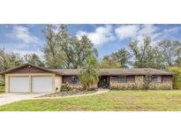 Charming ranch-style home featuring a stone facade, attached two-car garage, and a well-maintained front yard at 106 Frances Dr, Altamonte Springs, FL 32714