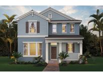 Charming two-story home with a covered porch, a well-manicured lawn and lush tropical landscaping at 18046 Cider Mill Ln, Winter Garden, FL 34787