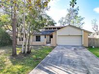 Charming single-Gathering home with a two-car garage and a well-manicured lawn at 234 N Griffin Dr, Casselberry, FL 32707