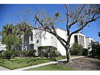 Well-maintained exterior of a condo building featuring lush landscaping and a welcoming walkway at 506 Orange Dr # 22, Altamonte Springs, FL 32701