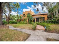 Charming Spanish-style home with lush landscaping, mature trees, and a tile roof at 1141 S Osceola Ave, Orlando, FL 32806