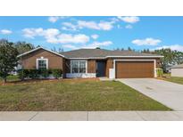 Charming single-Gathering home with a well-maintained lawn and a two-car garage at 13112 Tamarack Blvd, Clermont, FL 34711