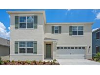 Charming two-story home with a two-car garage, green shutters, and freshly landscaped front yard at 4581 Boxwood Way, Mount Dora, FL 32757