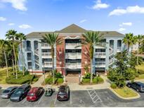 Beautiful condo building with tropical landscaping and ample parking at 7613 Cabana Ct # 402, Reunion, FL 34747