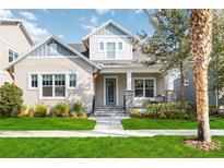 Charming two-story home featuring a landscaped front yard and welcoming front porch with swing at 7845 Dausset St, Orlando, FL 32827