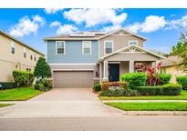 Charming two-story home with well-maintained landscaping, brick driveway, and a two-car garage at 14664 Spotted Sandpiper Blvd, Winter Garden, FL 34787