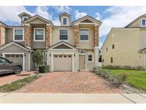 Charming townhome with a brick driveway and stone accents on the facade at 3167 Crown Jewel Ct, Winter Park, FL 32792