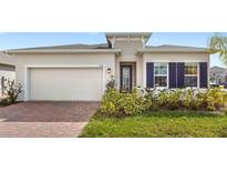 Charming single-story home featuring a two-car garage and well-maintained landscaping at 5593 Vigo Loop, St Cloud, FL 34771