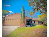 Charming single-Gathering home with a spacious two-car garage, well-manicured lawn, and mature landscaping at 1002 Royalton Rd, Orlando, FL 32825