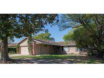 Charming single-story home featuring a well-maintained lawn and an attached two-car garage at 1002 Royalton Rd, Orlando, FL 32825