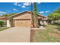 Charming single-story home with a two-car garage and mature landscaping at 1002 Royalton Rd, Orlando, FL 32825