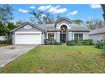 Charming single Gathering home showcasing well-maintained landscaping and attached two car garage at 1341 American Elm Dr, Altamonte Springs, FL 32714