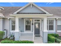 Inviting front porch with white railings and ceiling fan, creating a welcoming entrance at 14472 Chinese Elm Dr, Orlando, FL 32828