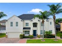 Stunning two-story home with lush landscaping, a brick driveway and attached two car garage at 15143 Ovation Dr, Winter Garden, FL 34787