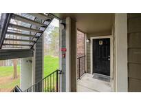 Exterior entryway featuring a black front door, outdoor lighting, and a stairway with a lawn view at 2200 Metropolitan Way # 926, Orlando, FL 32839