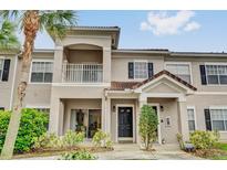 Inviting condo featuring two stories, a balcony, tile roof, and lush landscaping at 2314 Arbor Lakes Cir # 1, Sanford, FL 32771