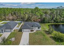 Expansive aerial view of home with beautiful pond, spacious yard, and two-car garage at 2875 E Slater Dr, Deltona, FL 32738