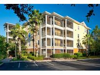 Beautiful three-story condo building with screened patios and lush landscaping and ample parking at 3050 Pirates Retreat Ct # 103, Kissimmee, FL 34747