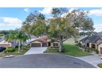 Aerial view of home on landscaped lot showcasing curb appeal and neighborhood setting at 32107 Spring Meadow Ct., Sorrento, FL 32776