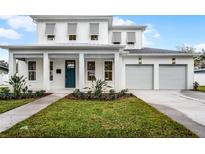 Beautiful two-story home featuring a manicured lawn, two-car garage, and welcoming front porch at 2248 Middleton Ave, Winter Park, FL 32792