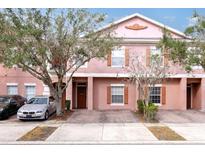 Charming two-story townhome with a brick driveway and landscaped yard, creating a welcoming curb appeal at 2328 Caravelle Cir, Kissimmee, FL 34746