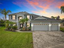 Beautiful two story home featuring a three car garage, lush landscaping, and a grand entryway at 3840 Stone Pine Ct, Oviedo, FL 32766