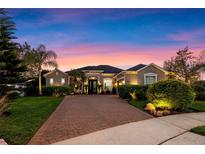 Beautiful single-story home featuring a large brick driveway and meticulously manicured landscaping at 3930 Hydrangea Ct, Oviedo, FL 32766