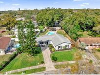Aerial view of a well-maintained property with lush landscaping, a pool, and a charming single-Gathering home at 615 Pershing Dr, Altamonte Springs, FL 32701