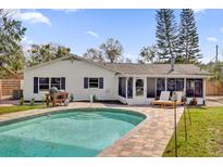Back exterior view featuring a refreshing pool, screened-in porch, and outdoor lounge area at 615 Pershing Dr, Altamonte Springs, FL 32701