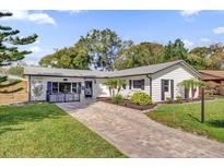 Charming single-story home with a brick driveway and manicured lawn at 615 Pershing Dr, Altamonte Springs, FL 32701