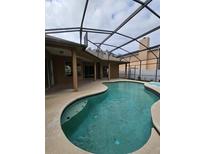 Inviting screened-in pool featuring a spa and a spacious deck area, perfect for outdoor relaxation and entertainment at 7741 Bardmoor Hill Cir, Orlando, FL 32835